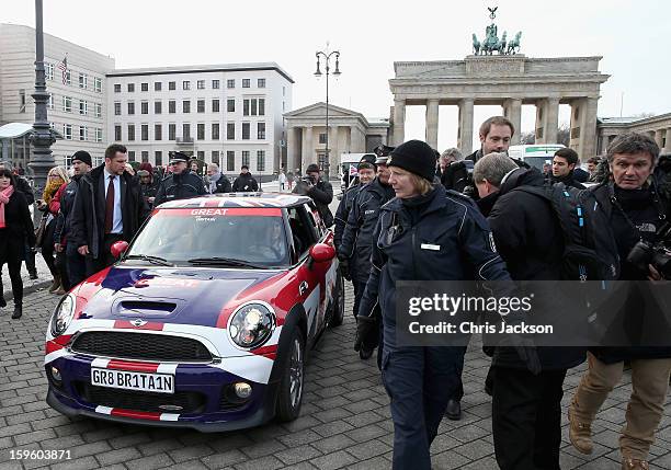 Princess Beatrice and Princess Eugenie drive a Mini in front of Brandenburg Gate as they promote the GREAT initiative on January 17, 2013 in Berlin,...