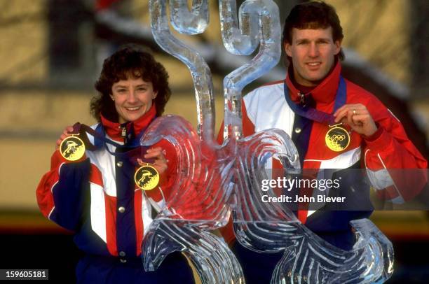 Winter Olympics: Portrait of USA Bonnie Blair and Dan Jansen posing victorious behind ice sculpture with their gold medals in front of Vikingskipet...