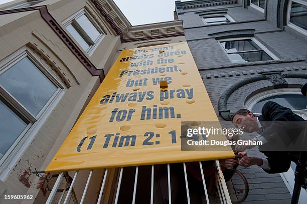 Jan 17 : Peggy Nienaber and Rev. Rob Schenck of Faith and Action secure a banner at the Faith and Action building. Clergy leaders put the banner up...