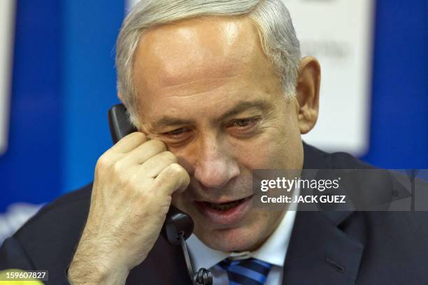 Israeli Prime Minister Benjamin Netanyahu talks to potentiel voters in an attempt to convince them to vote for his party in Tel Aviv on January 17,...