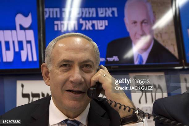 Israeli Prime Minister Benjamin Netanyahu talks to potentiel voters in an attempt to convince them to vote for his party in Tel Aviv on January 17,...