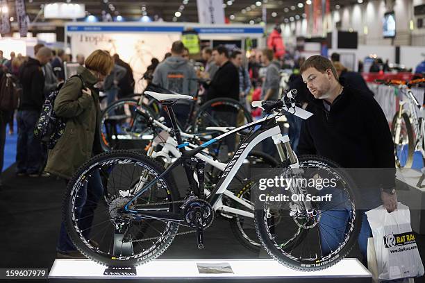 Man admires a Canyon mountain bike at the London Bike Show which is being held in the ExCeL Centre on January 17, 2013 in London, England. The ExCeL...