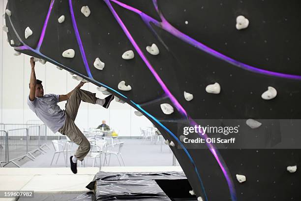 Man practices his bouldering at The Outdoors Show which is being held in the ExCeL Centre on January 17, 2013 in London, England. The ExCeL centre is...