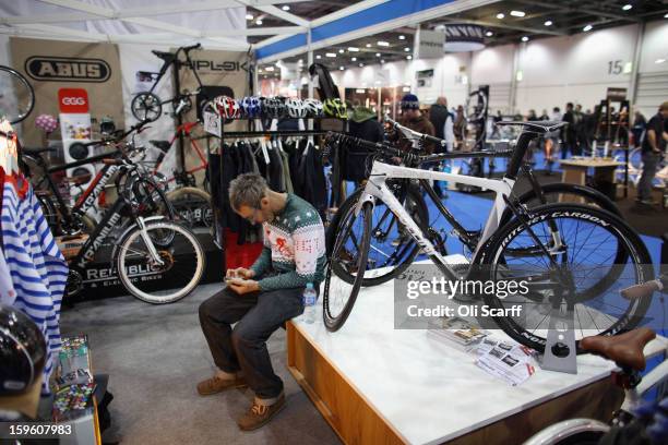 The man uses his phone on a stand at the London Bike Show which is being held in the ExCeL Centre on January 17, 2013 in London, England. The ExCeL...