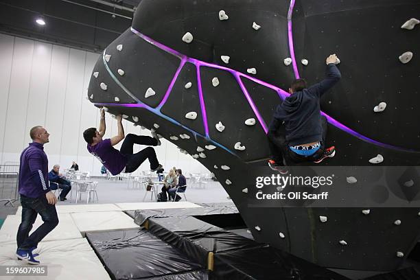 Men practice their bouldering at The Outdoors Show which is being held in the ExCeL Centre on January 17, 2013 in London, England. The ExCeL centre...