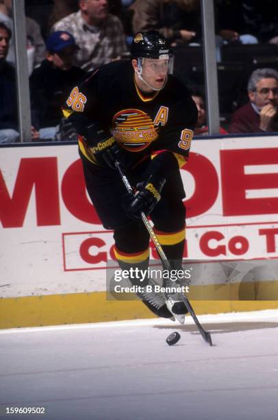 Pavel Bure of the Vancouver Canucks skates with the puck during an NHL game against the New York Rangers on November 11, 1996 at the Madison Square...