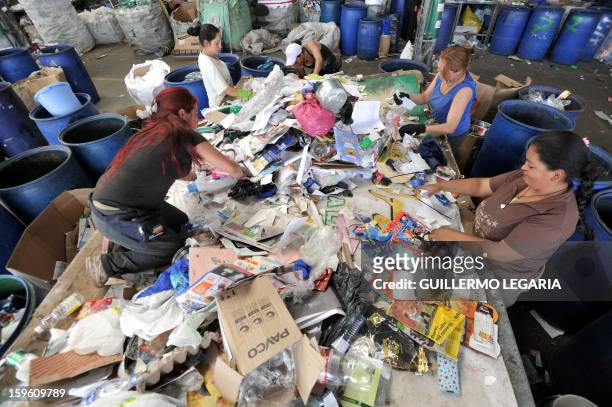 Women classify recyclable garbage at La Alqueria Recycling Center in Bogota, Colombia, on January 17, 2013. Some 60 recyclers classify 10 tons daily...