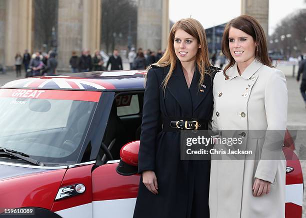 Princess Beatrice and Princess Eugenie pose next to a Mini in front of Brandenburg Gate as they promote the GREAT initiative on January 17, 2013 in...