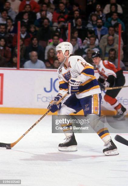 Adam Oates of the St. Louis Blues skates with the puck during an NHL game against the Philadelphia Flyers on February 2, 1992 at the Spectrum in...