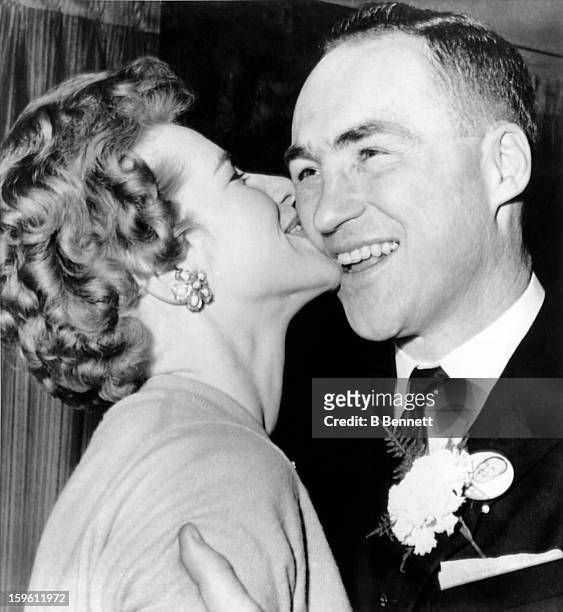 Red Kelly of the Toronto Maple Leafs is kissed by his wife Andra as he was re-elected as a Member of Parliament before Game 1 of the 1963 Stanley Cup...