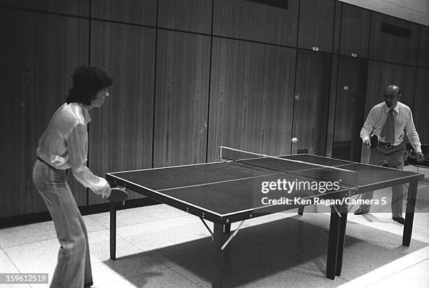 Bill Wyman of the Rolling Stones and record producer Ahmet Ertegun are photographed playing ping pong backstage in 1975 in Baton Rouge, Louisiana....