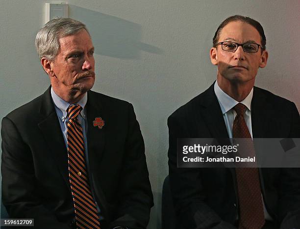 Chairman George McCaskey of the Chicago Bears sits with new head coach Marc Trestman during an introductory press conference at Halas Hall on January...