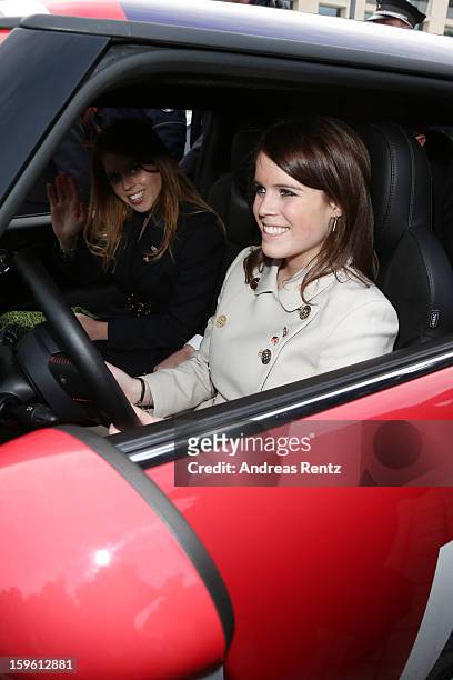 Princess Beatrice and Princess Eugenie drive a Mini in front of Brandenburg Gate as she promotes the GREAT initiative on January 17, 2013 in Berlin,...
