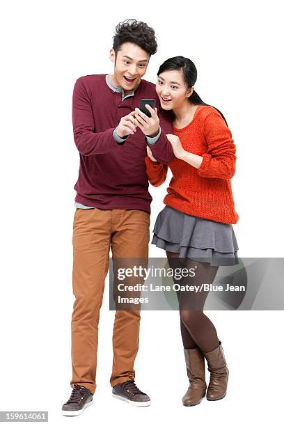 surprised young couple with smart phone in chinese new year - two women on phone isolated stock pictures, royalty-free photos & images