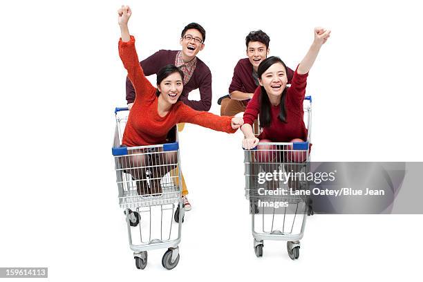 excited young friends with shopping cart in chinese new year - man pushing cart fun play stock pictures, royalty-free photos & images