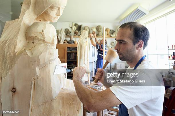 sculptor chiseling figure from wood - carving sculpture stock pictures, royalty-free photos & images