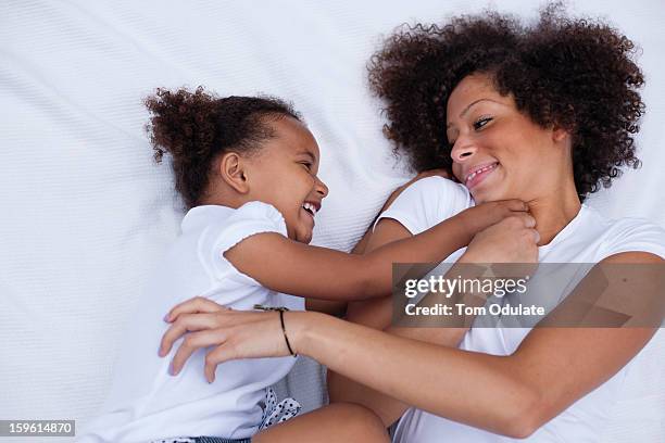 mother and daughter playing together - cócegas imagens e fotografias de stock