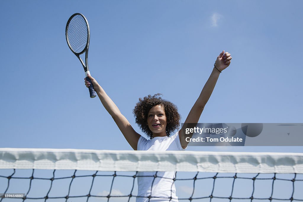 Tennis player cheering on court