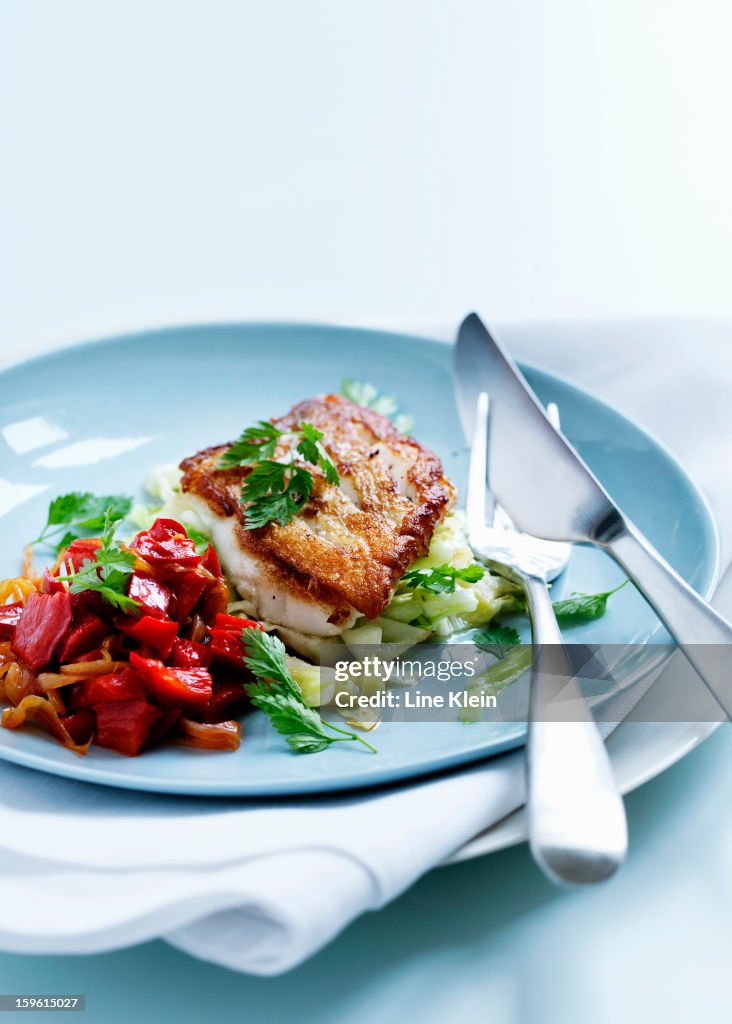Plate of fried fish and salad