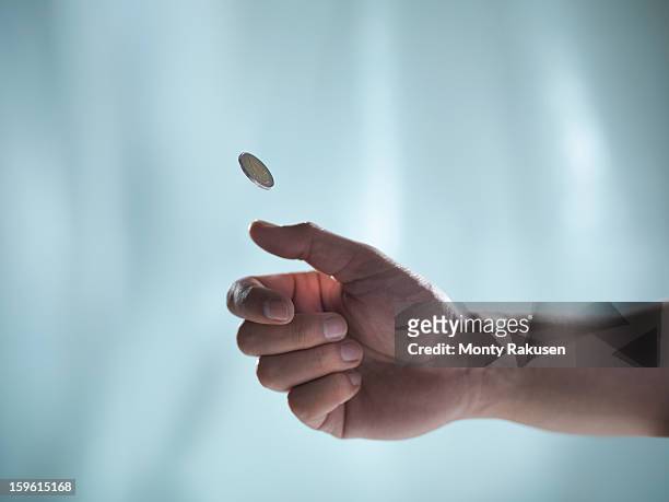 man flipping euro coin - flipping a coin stock pictures, royalty-free photos & images