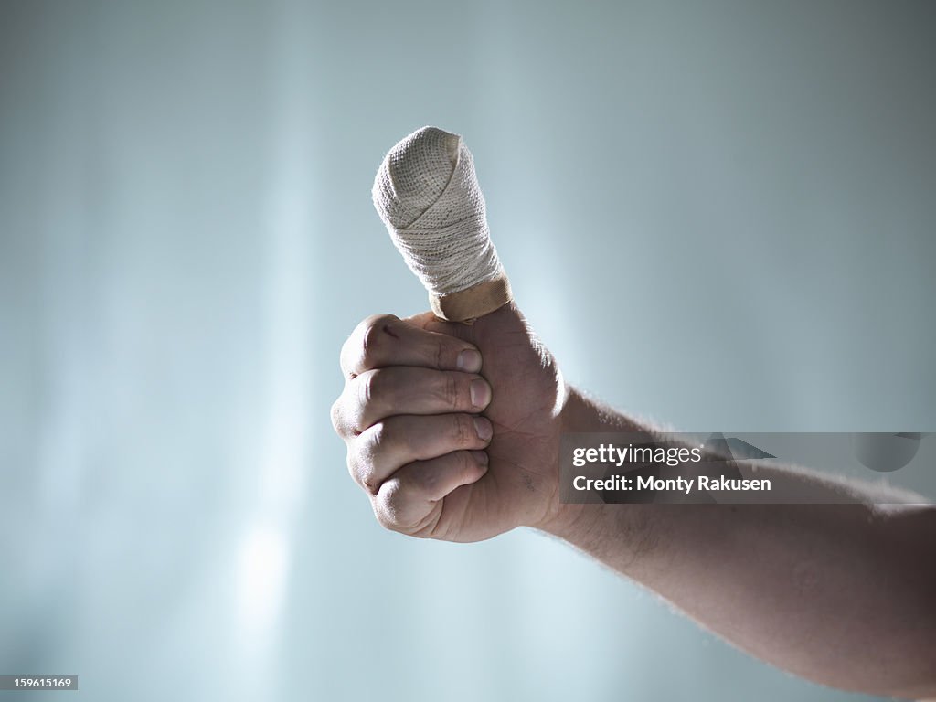 Man with bandaged thumb