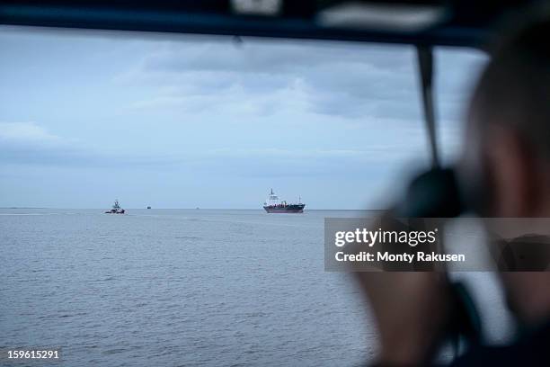 tug captain's view through window towards tug and ship out at sea - ship captain stock pictures, royalty-free photos & images