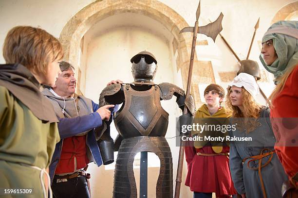 students and teacher with armour, bolton castle, 14th century grade 1 listed building, scheduled ancient monument - tour guide costume stock pictures, royalty-free photos & images