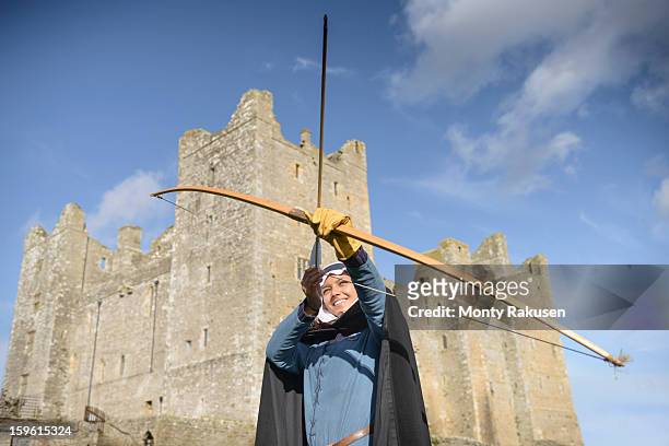 history student learning archery in period dress outside bolton castle, a 14th century grade 1 listed building, scheduled ancient monument - archery stock pictures, royalty-free photos & images