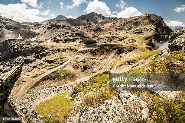 clouds over grassy rural landscape - lenzerheide stock pictures, royalty-free photos & images