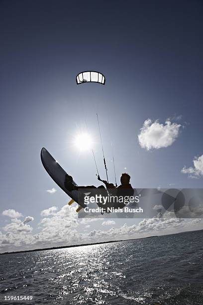 man kite surfing on calm water - kite surfing stock pictures, royalty-free photos & images
