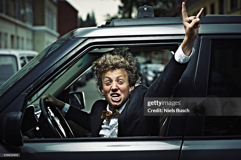 Teenage boy cheering while driving