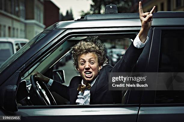 teenage boy cheering while driving - driving humor stock pictures, royalty-free photos & images