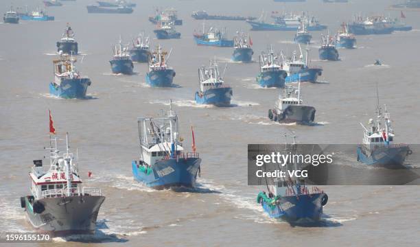 Fishing boats set sail for fishing after the summer fishing ban on the East China Sea was partially lifted on August 6, 2023 in Zhoushan, Zhejiang...