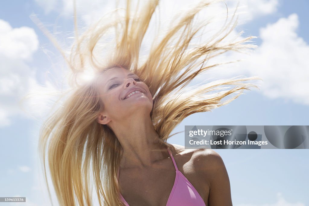 Smiling woman tossing her hair