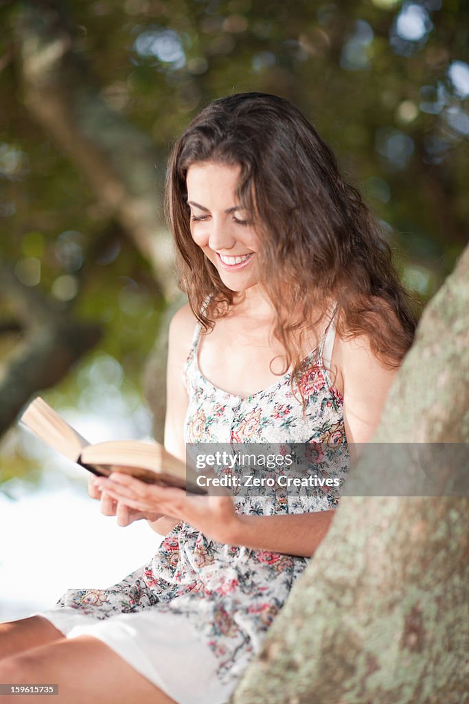 Woman Reader Woman Reading Book In Tree Outdoors High-Res Stock Photo - Getty Images