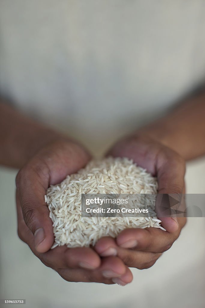 Close up of hands holding rice