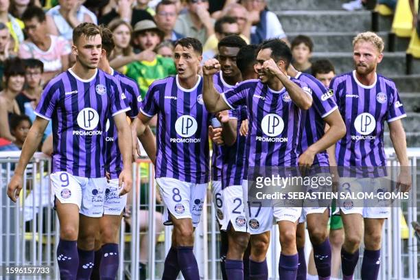 Toulouse's players celebrate after a goal by their Danish defender Rasmus Nicolaisen during the French L1 football match between FC Nantes and...