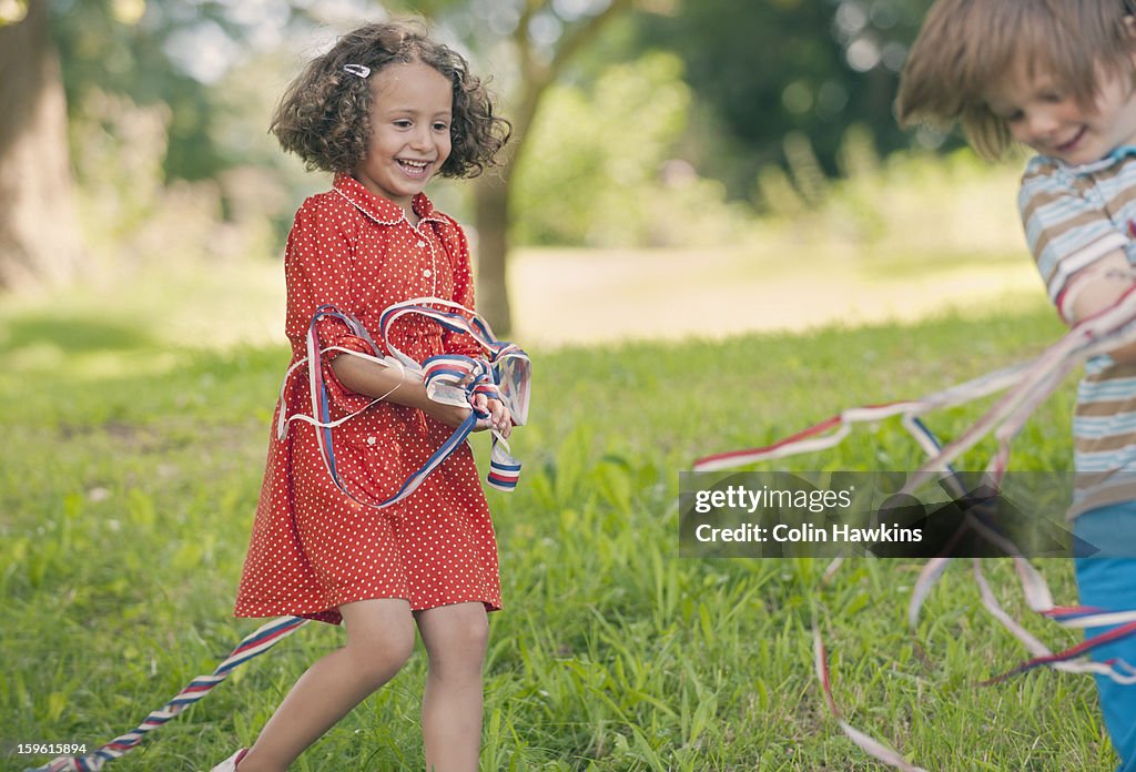 Children playing with ribbons outdoors
