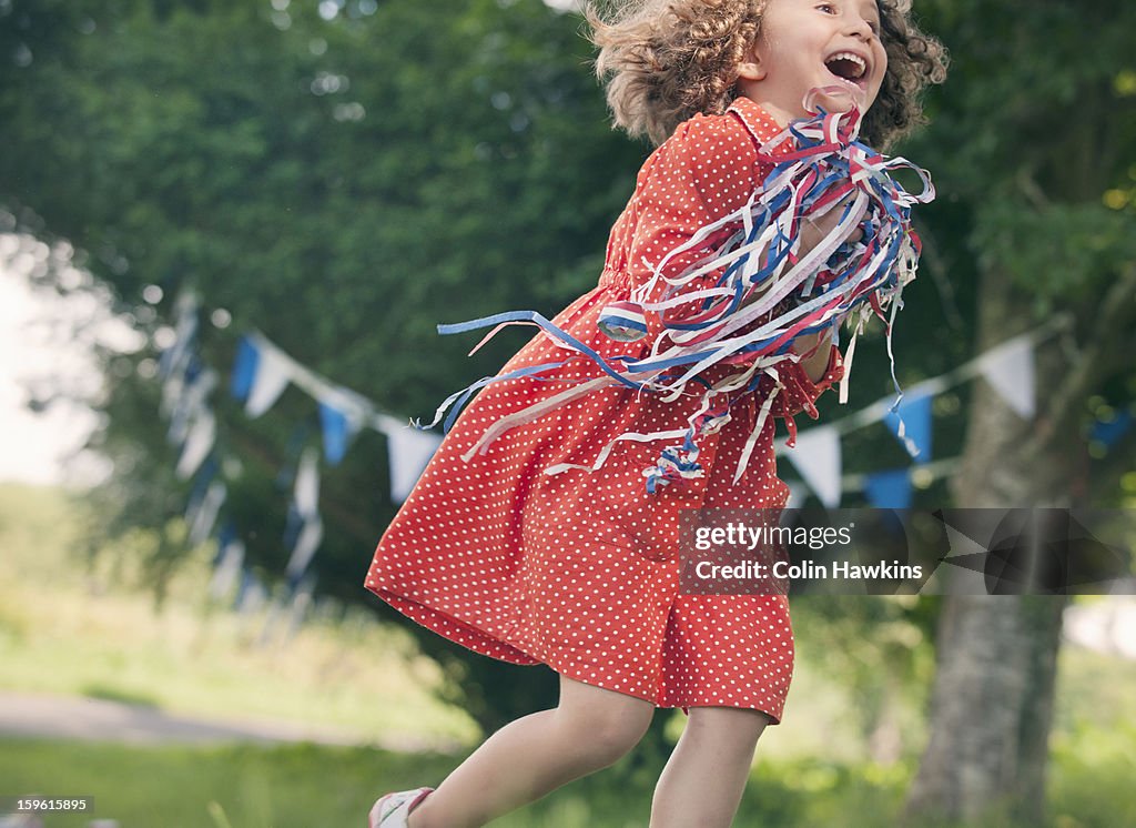 Girl playing with ribbons outdoors
