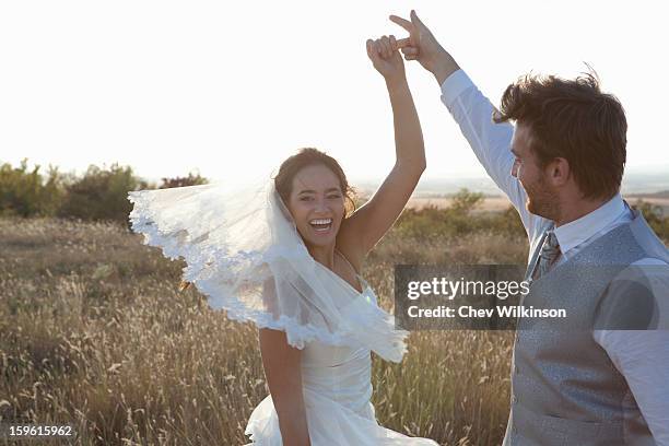 newlywed couple dancing outdoors - rural scene wedding stock pictures, royalty-free photos & images