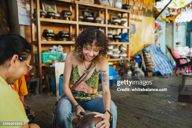 young asian woman enjoying experiential travel. - alms stock pictures, royalty-free photos & images