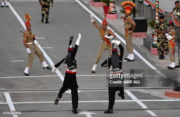 Pakistani Rangers and Indian Border Security Force soldiers take part in 'Beating the Retreat' ceremony on the eve of Pakistan's Independence Day...