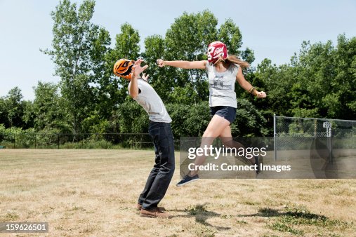 Couple wearing wrestling masks play fighting Couple wearing wrestling masks play fighting