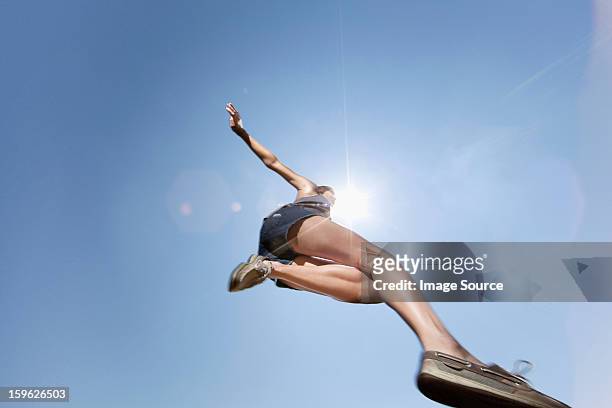 girl jumping against blue sky, low angle - tween heels stock pictures, royalty-free photos & images