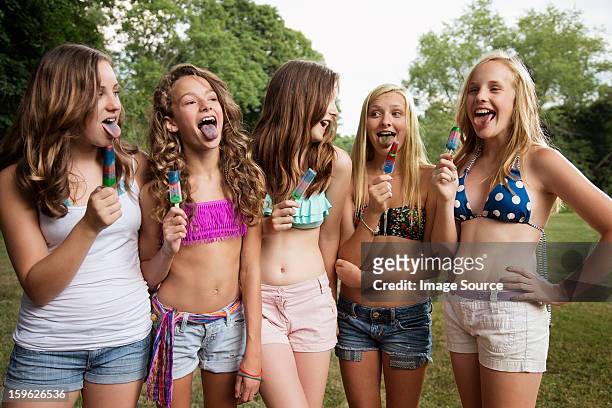 girls eating ice lollies - 13 year old girls in shorts stock pictures, royalty-free photos & images