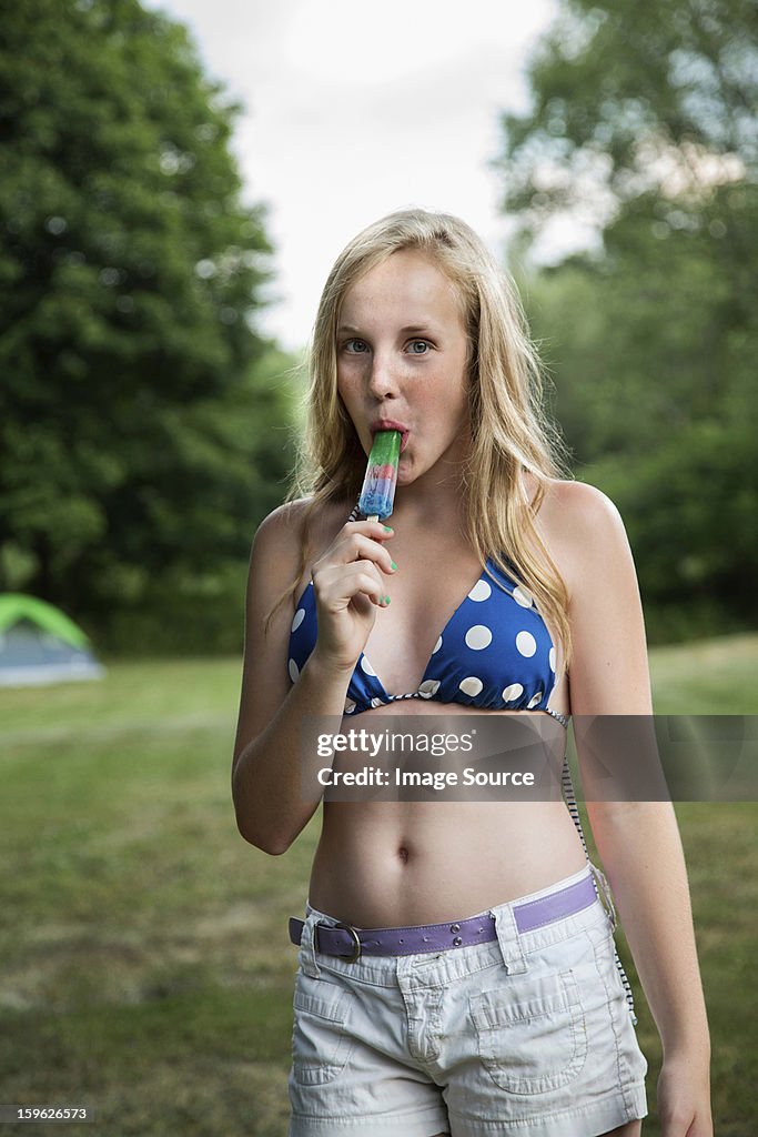 Portrait of girl eating ice lolly