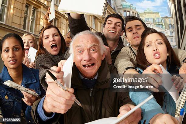 group of people asking for autographs - crowd anticipation stock pictures, royalty-free photos & images