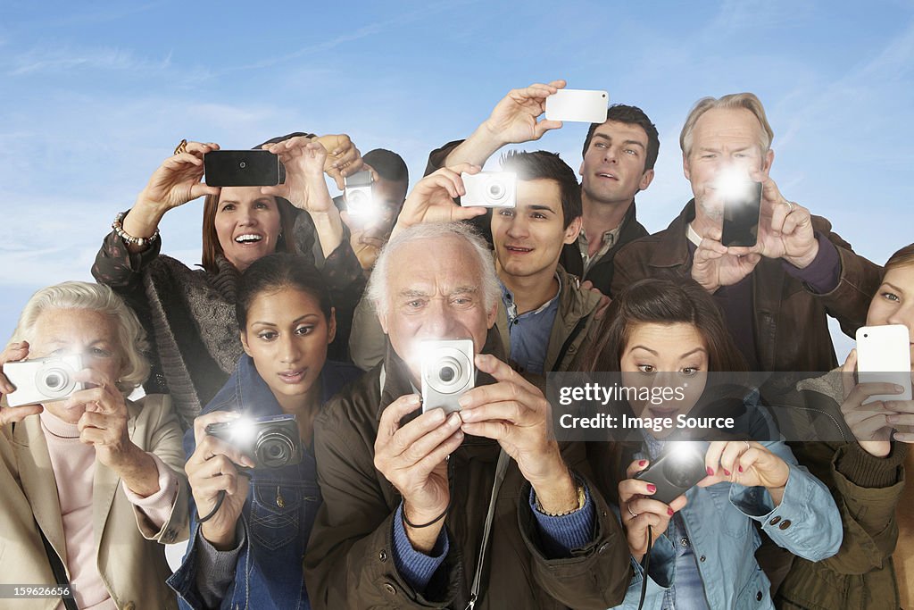 Group of people taking photographs