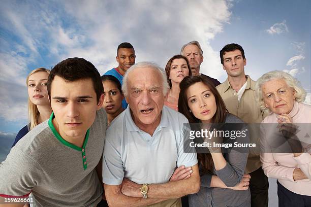 group of people looking angrily at camera - angry people stockfoto's en -beelden