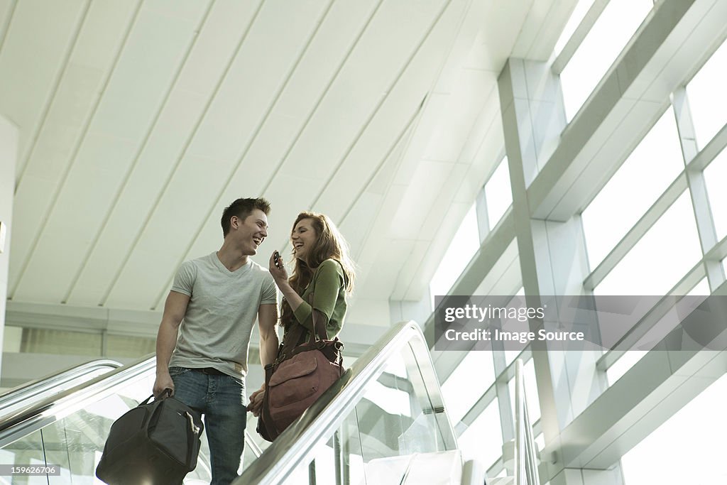 Young couple travelling on escalator